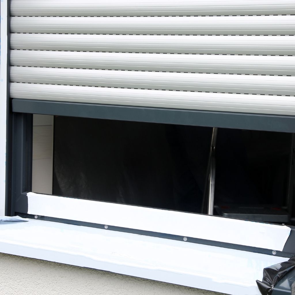 Custom roller shutters installed on large glass windows